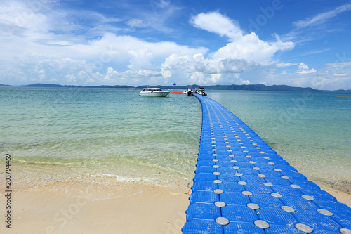 Pack Group of Blue Cubes Float on clear Ocean beautiful beach for tourist to walk from boat photo