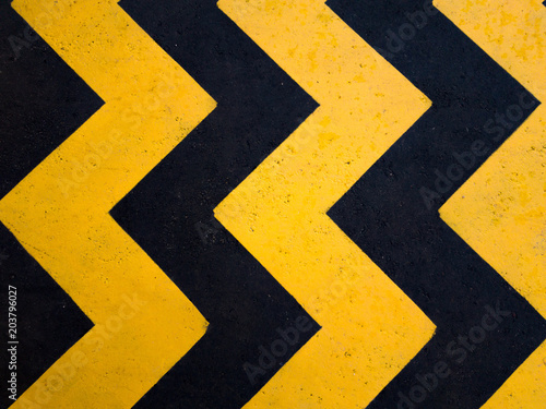 A yellow stripe speed ramp on concrete road.