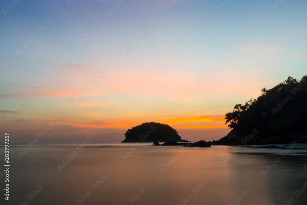 Sea at sunset.Seascape of smooth blurred sea water and small island at sunset with twilight sky and cloud  long exposure photograph.