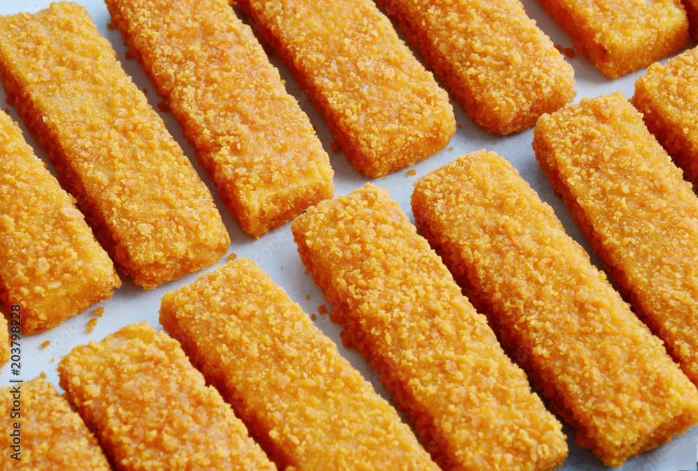 frozen fish sticks in Tray for oven on wooden background.
convenience food. frozen fish sticks in Tray for oven on wooden background.
convenience food.