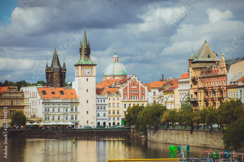 view on the red roofs and church and river of old European city. Prague