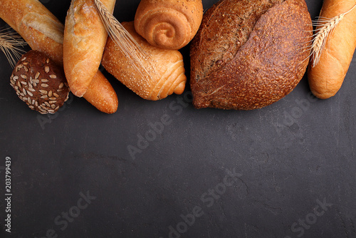 Pile of fancy bread on black stone background