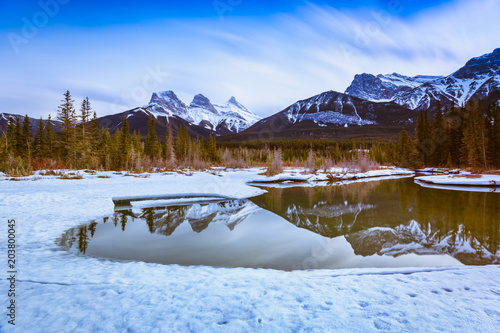 Three Sisters Mountain at Canmore, Alberta, Canada. This photo was taken during the transition between winter and snow season. © Aqnus