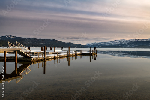 Boat dock and reflection on an Idaho mountain lake in the morning