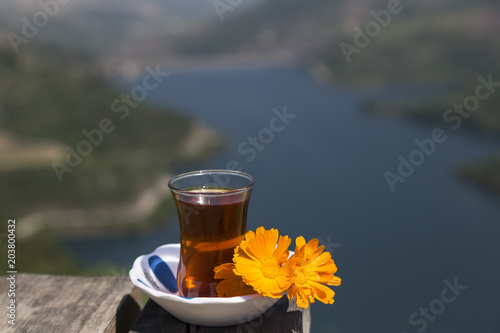 someone holds the tea in the hand. A beautiful view of pleasure. Yuvacik is the great place to relax at the weekend. photo