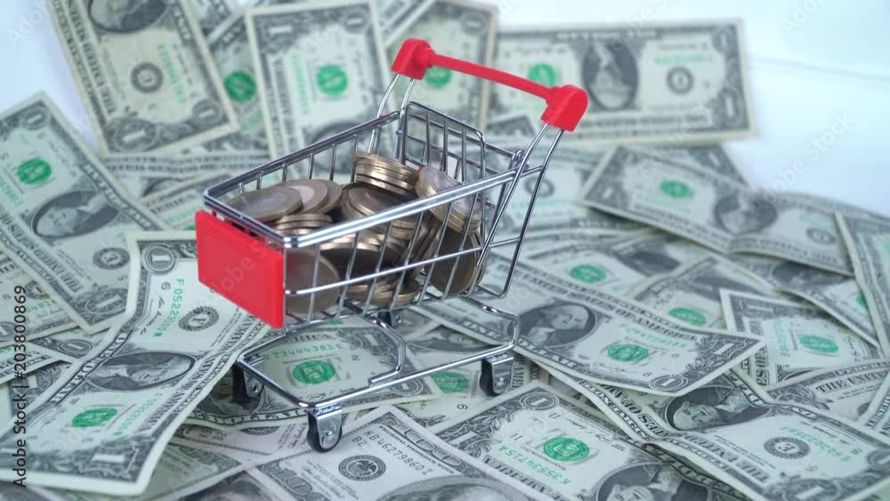 Coins in the mini market trolley. on dollars Coins in the mini market trolley. on dollars