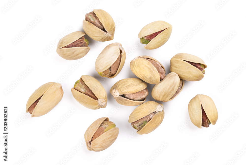 handful of salted pistachios isolated on white background macro shot