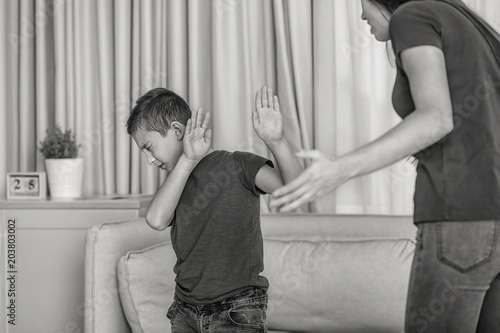 Slika na platnu Woman scolding her son at home, black and white effect