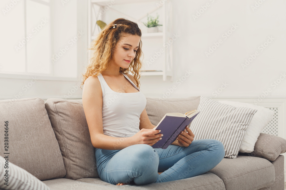 Cozy home. Young thoughtful woman with book Cozy home. Young thoughtful woman with book