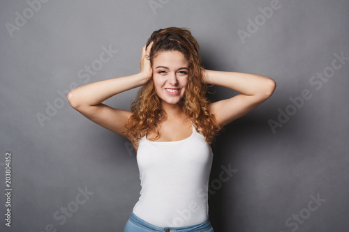 Cheerful girl with hands in hair portrait © Prostock-studio