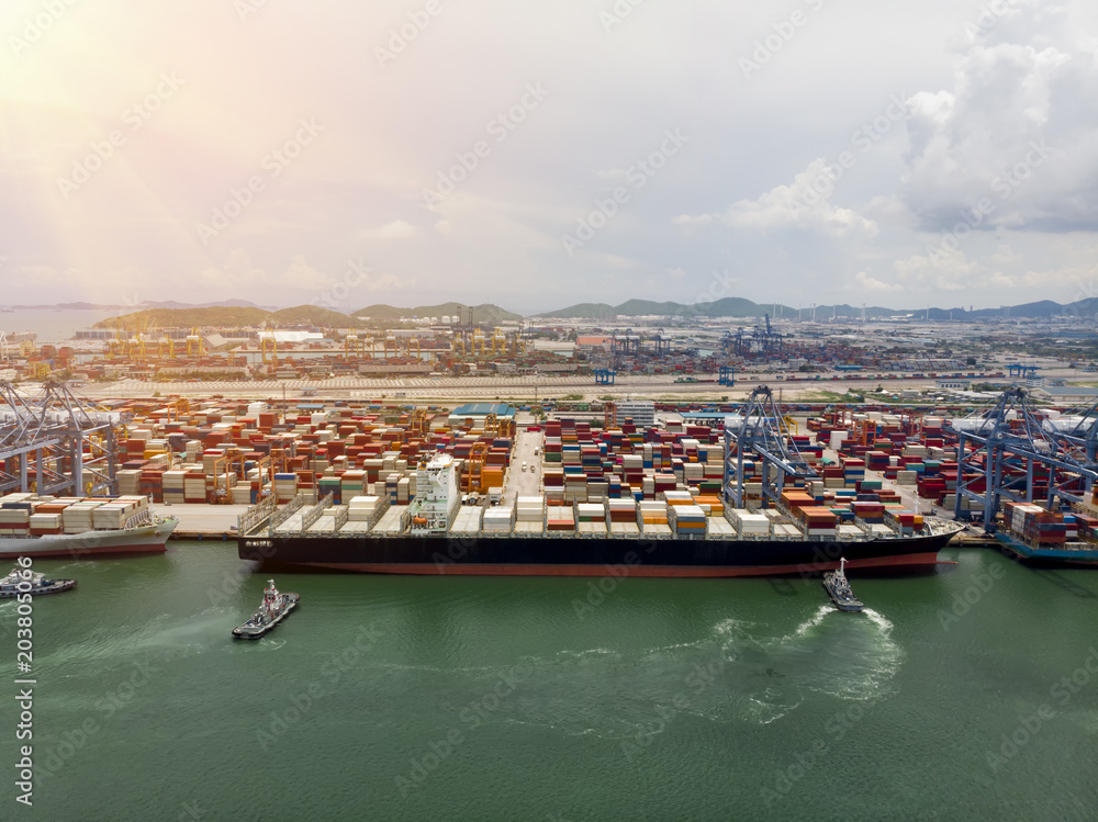 Naklejka premium Cargo ship with container at the cargo international yard port for transportation freight shipping by ship concept.