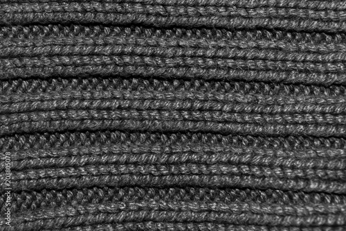 Texture of knitted fabric. Stranded threads. Cloth of warm winter clothes. Warm blanket. The texture of the blue gray and black threads. Background.