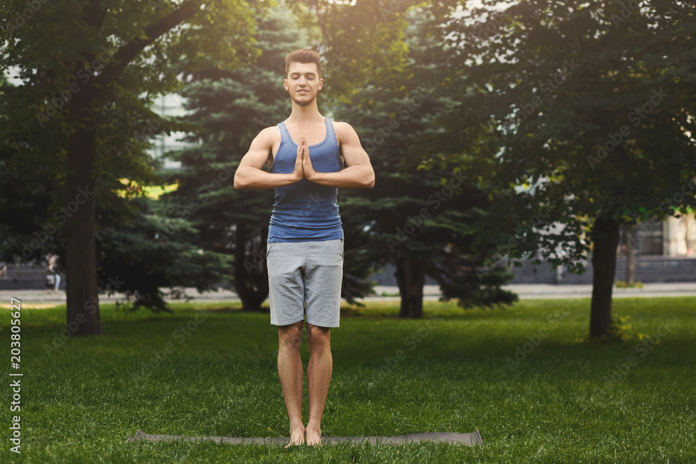 Meditating man with praying hands outdoors Meditating man with praying hands outdoors