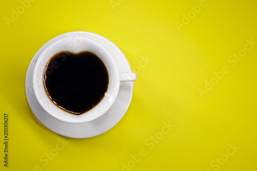 coffee on a colored background top view, white Cup in the shape of a heart