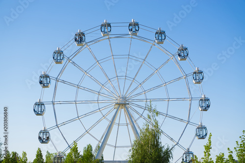Ferris wheel on blue sky background