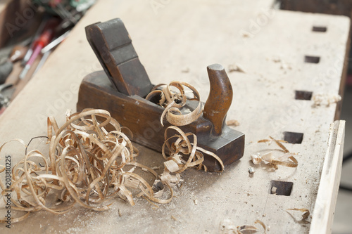 carpenter hand plane on wooden background