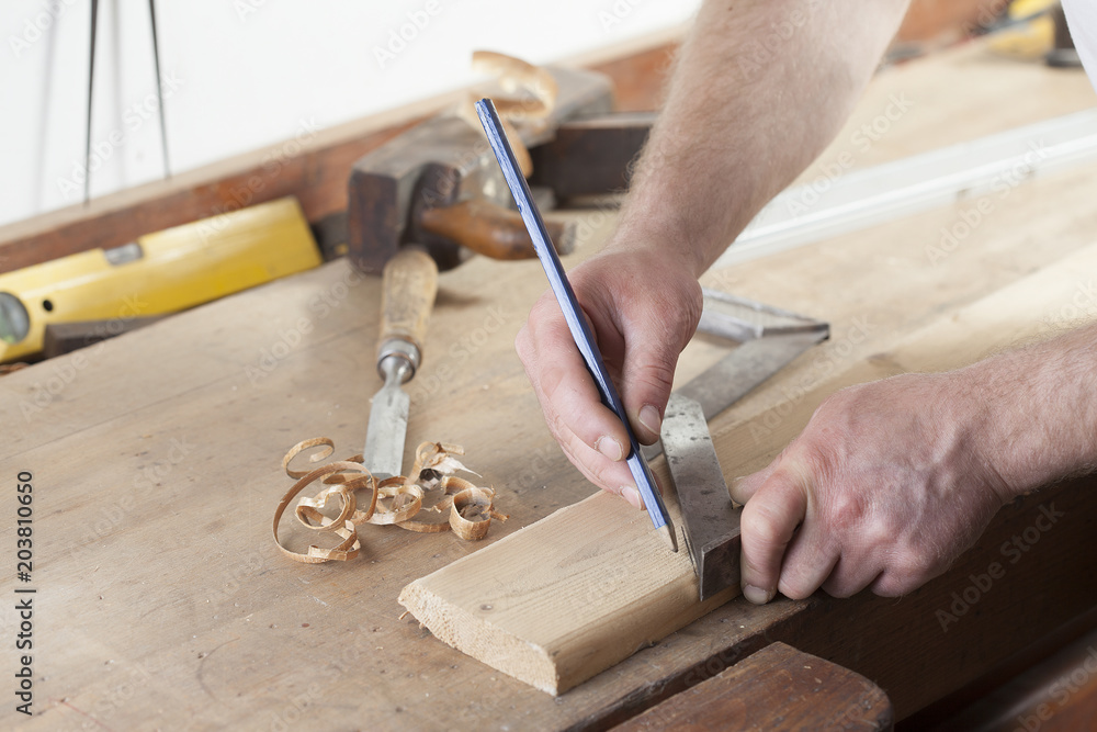 carpenter drawing on a wooden board.copy space carpenter drawing on a wooden board.copy space