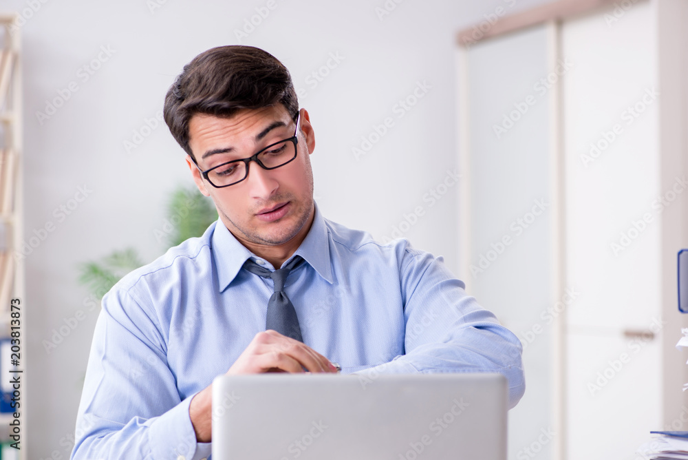 Extremely busy businessman working in office Extremely busy businessman working in office