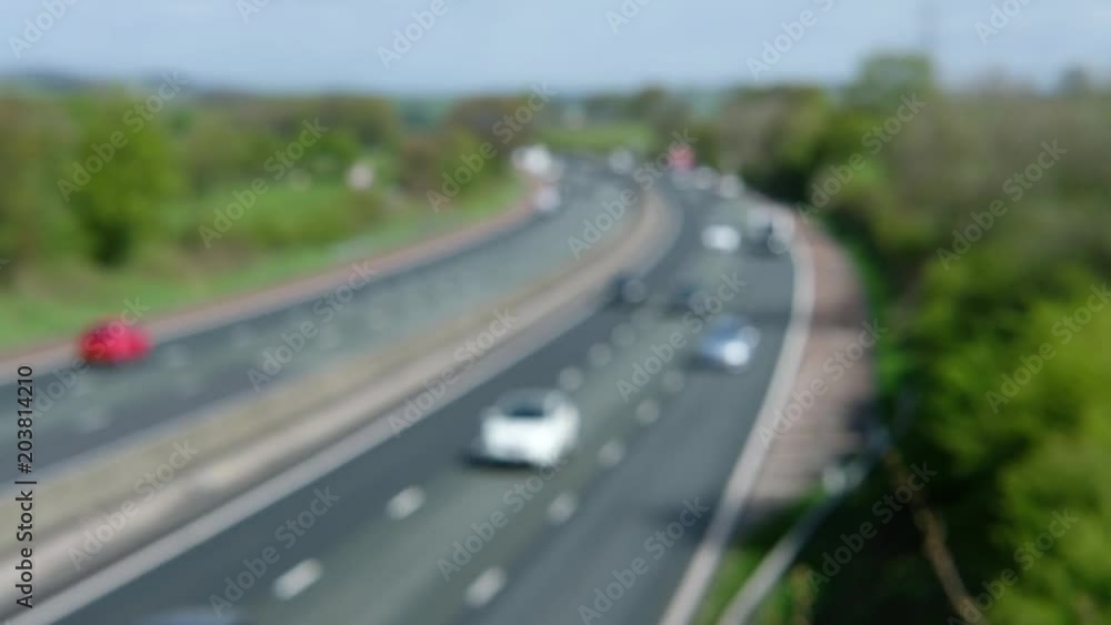 De-focused traffic on the M6 Motorway at Lancaster, UK on a bright April morning De-focused traffic on the M6 Motorway at Lancaster, UK on a bright April morning