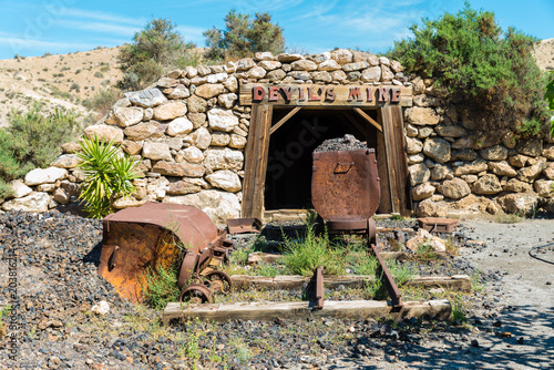 Entrance to a mining shaft with old timbers photo