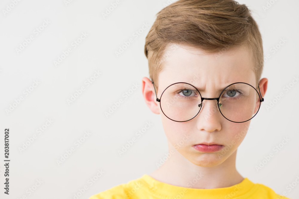 Serious teen boy with big glasses and yellow t-shirt Serious teen boy with big glasses and yellow t-shirt