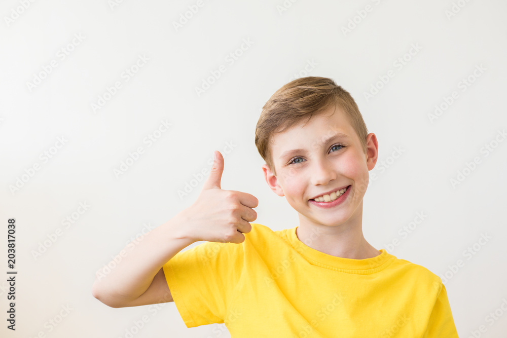 Young fresh teenager is posing with a thumb up sign Young fresh teenager is posing with a thumb up sign