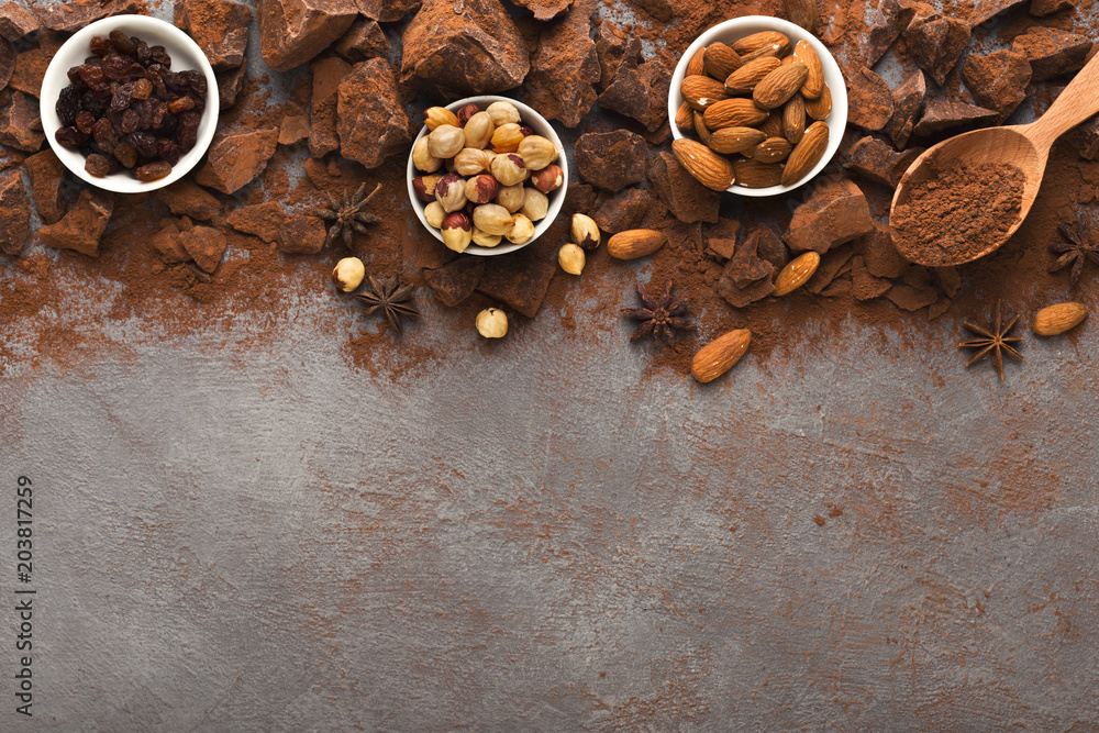 Crushed chocolate pieces and cocoa on gray background, top view Crushed chocolate pieces and cocoa on gray background, top view