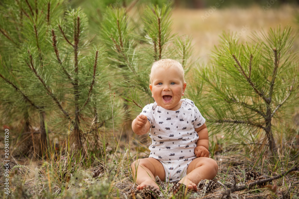 Portrait of a baby boy in green pine forest Portrait of a baby boy in green pine forest