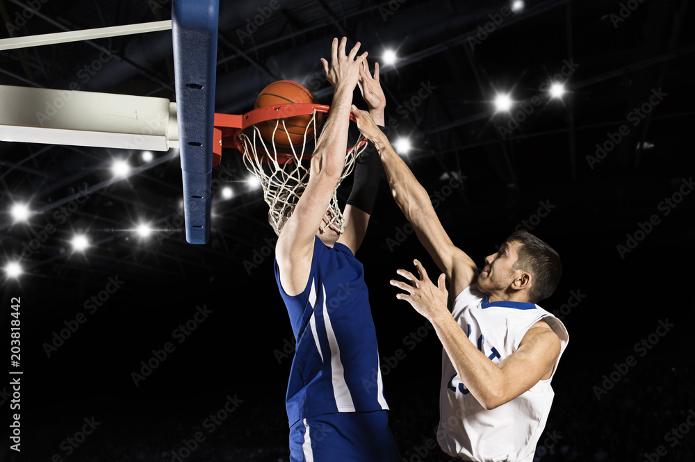 Fototapeta premium Two basketball players in action