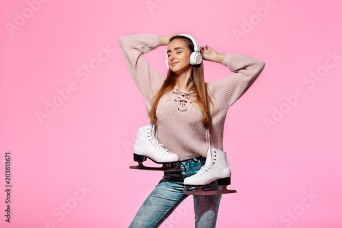 attractive woman holding ice skates photo