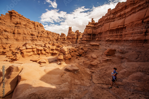 A mother and her baby son visit Goblin valley state park in Utah, USA