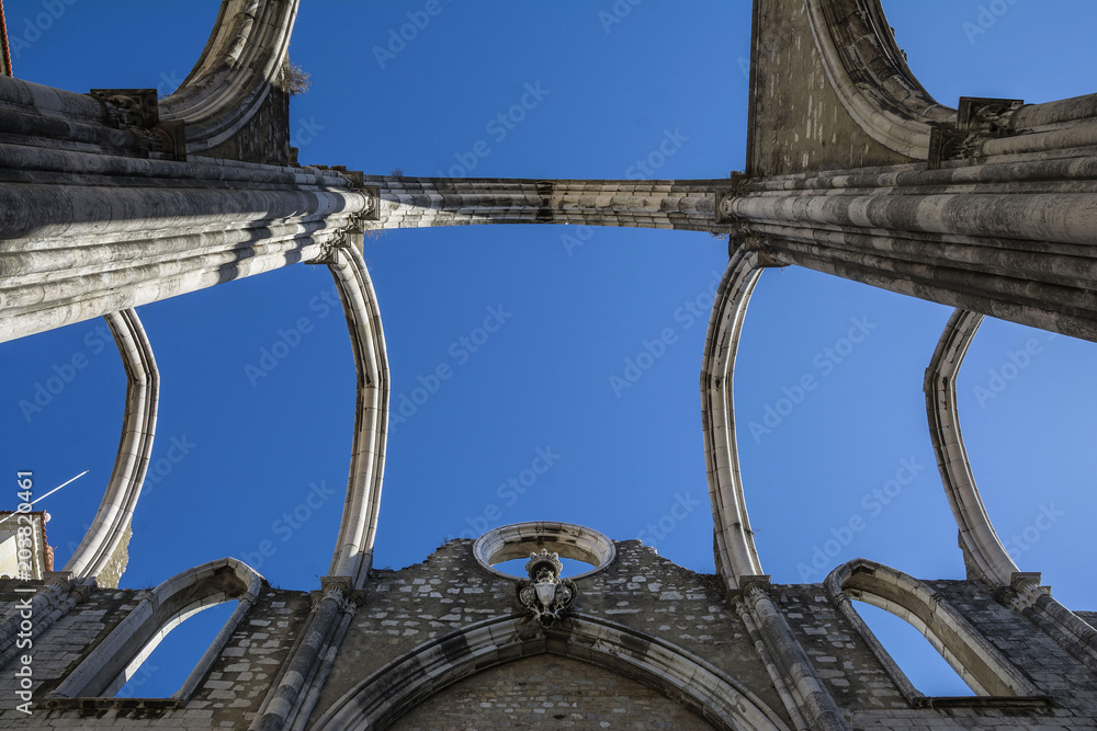 Fototapeta premium The ruins of the Carmo Church and Convent, destroyed in the earthquake 1755, amazing attraction in Lisbon, Portugal.