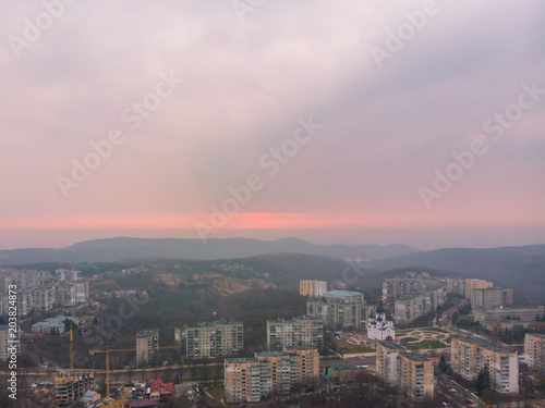 beautiful cityscape with sunrise. red sun rise above the mountains