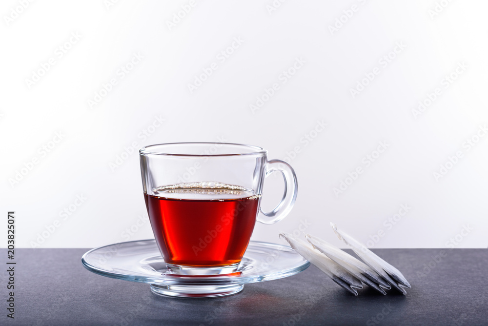 Cup and saucer with herbal tea on a white background