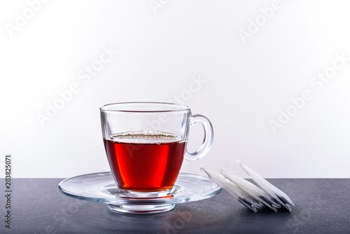Cup and saucer with herbal tea on a white background