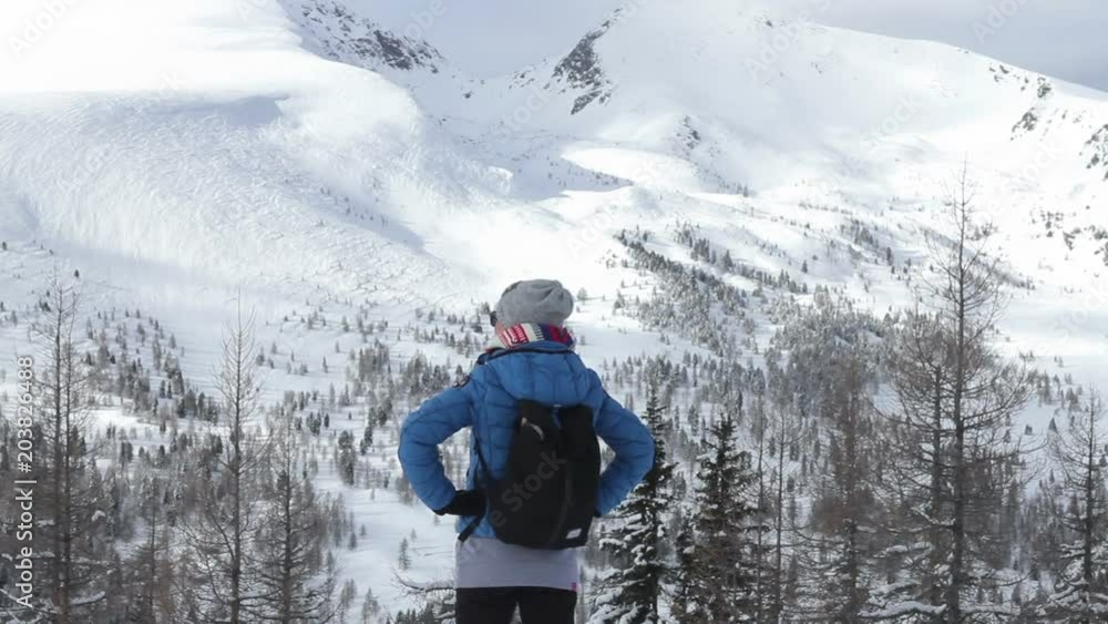 Woman in the snowy mountains looking at beautiful view, Alps, Austria
Woman in the snowy mountains looking at beautiful view, Alps, Austria