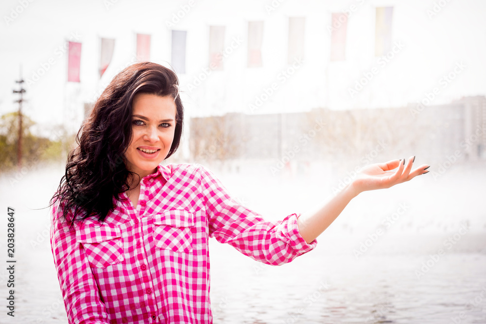 Smiling and happy girl is pointing by hand on something. Smiling and happy girl is pointing by hand on something.