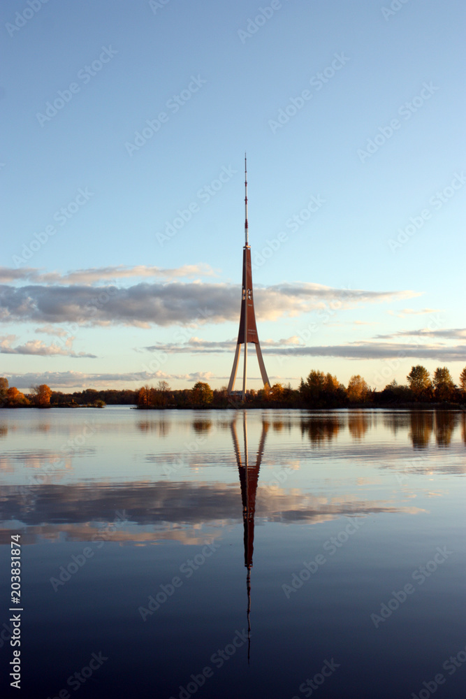 Fototapeta premium The tv tower is reflected in the water, in the evening. Riga, Latvia