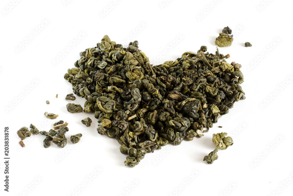 High quality dry green tea isolated on white background. Leaves of tea in the form of a heart. Pekoe tea. High quality dry green tea isolated on white background. Leaves of tea in the form of a heart. Pekoe tea.