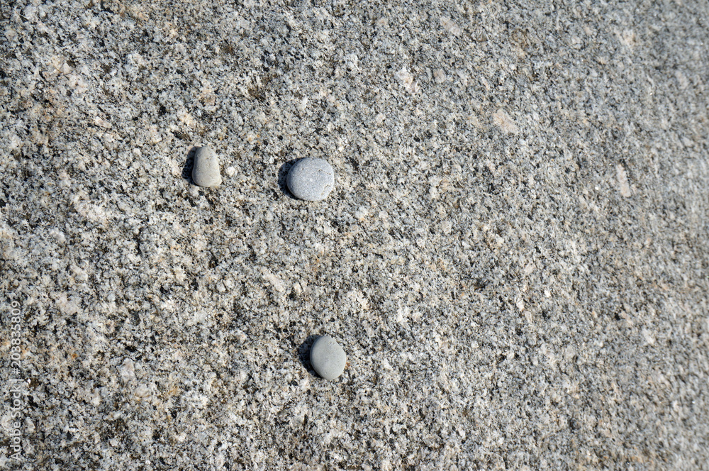 Light grey natural seamless granite stone texture pattern background with 3 small stones. Grey natural stone seamless . Gray grungy textured backdrop. Light grey natural seamless granite stone texture pattern background with 3 small stones. Grey natural stone seamless . Gray grungy textured backdrop.