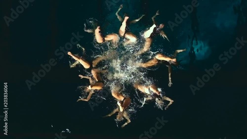 Synchronized swimmers performing underwater