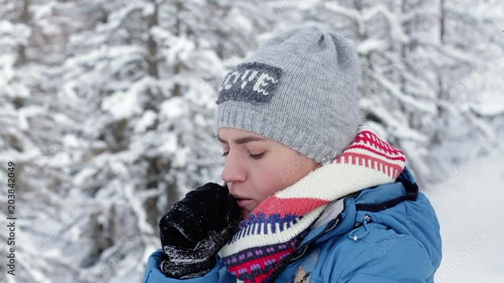 Young woman coughing in winter park, slow motion Young woman coughing in winter park, slow motion