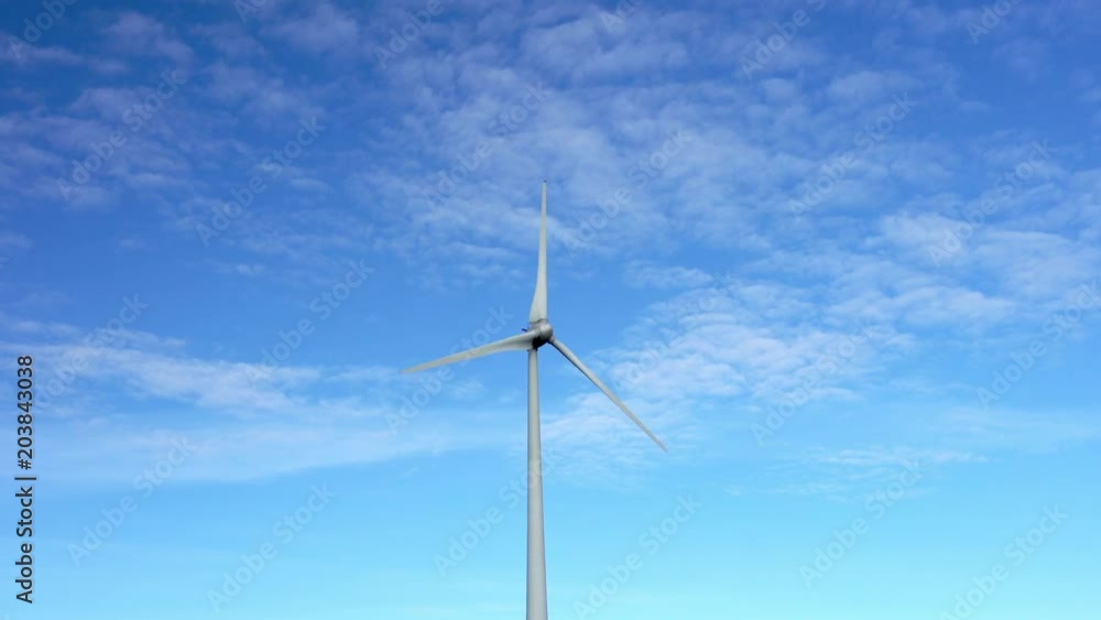 top part electrical windmill standing alone sunny day sweden almost no clouds on blue sky slow rotation weak wind top part electrical windmill standing alone sunny day sweden almost no clouds on blue sky slow rotation weak wind