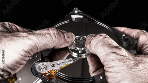 Photos Dirty hands on hard disk drive