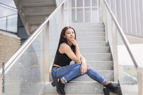 girl sitting on a stairs with fashion pose