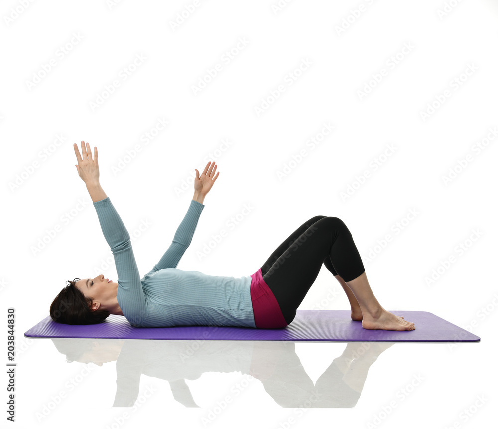 Mother woman exercising doing postnatal workout. Female fitness instructor stretching hands and legs in gym and work out exercises Mother woman exercising doing postnatal workout. Female fitness instructor stretching hands and legs in gym and work out exercises