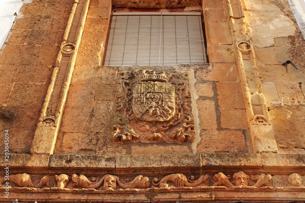 Old facade of majestic house with coat of arms in Alcaraz, Spain Old facade of majestic house with coat of arms in Alcaraz, Spain