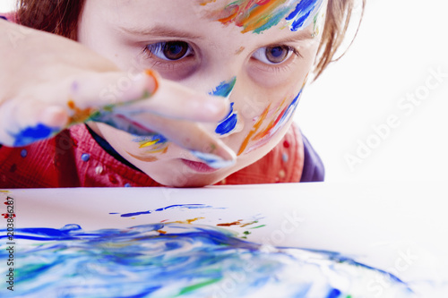 Child girl painting with colorful hands. ( people, childhood, drawing concept)