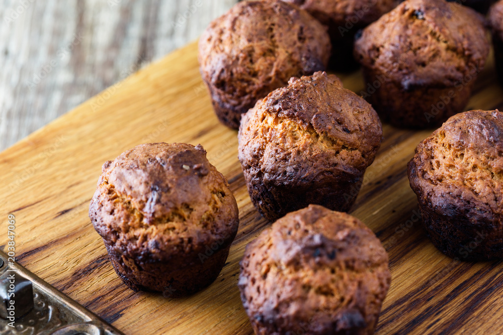 Burnt muffins on rustic wooden table Burnt muffins on rustic wooden table