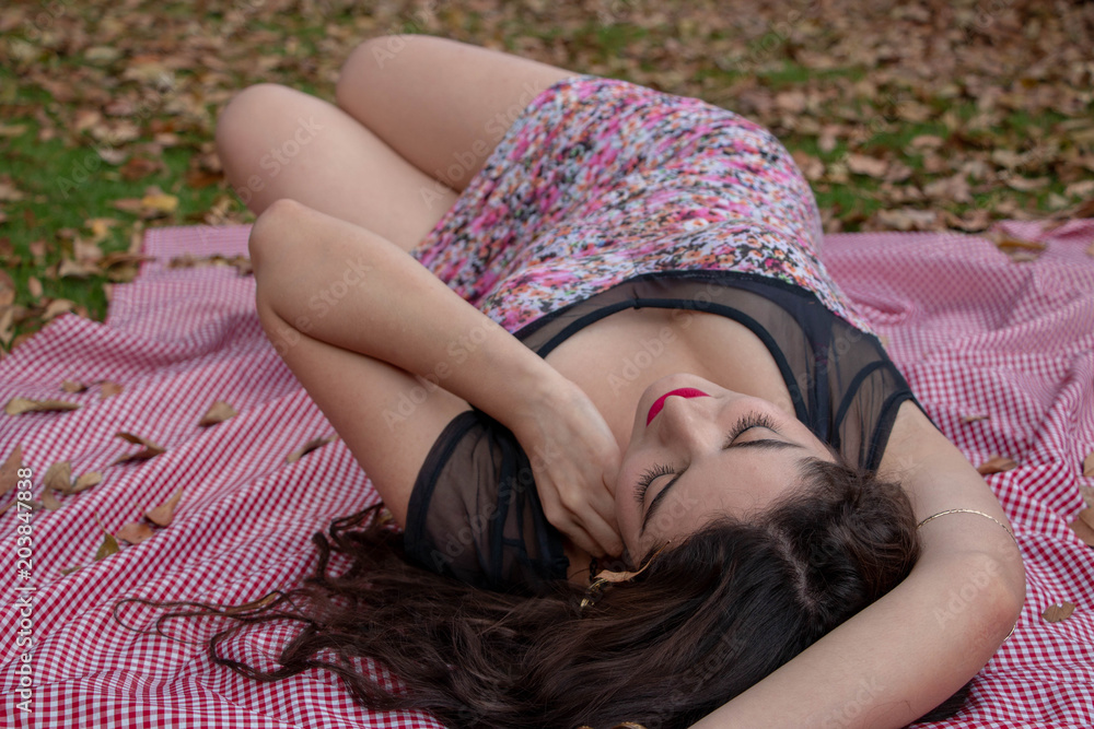 Naklejka premium Gorgeous young latina relaxing in the park 
